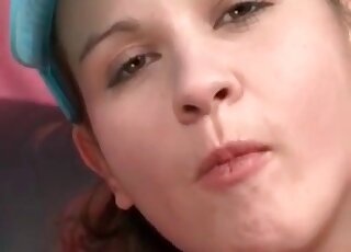 Cute brunette in lingerie and a cap is showing off