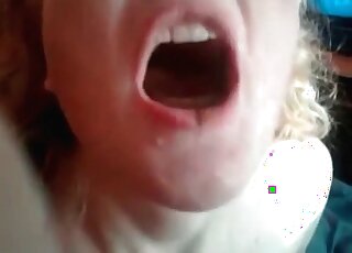 Opening her mouth wide open and showing the poop